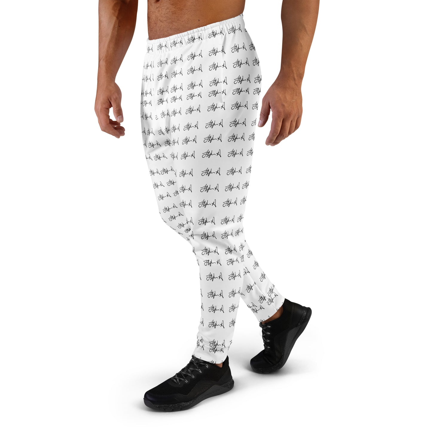 White athletic jogger pants with an all-over black graffiti-style pattern, shown on a male model from the waist down wearing black sneakers against a plain white background. Stephen Allen Music