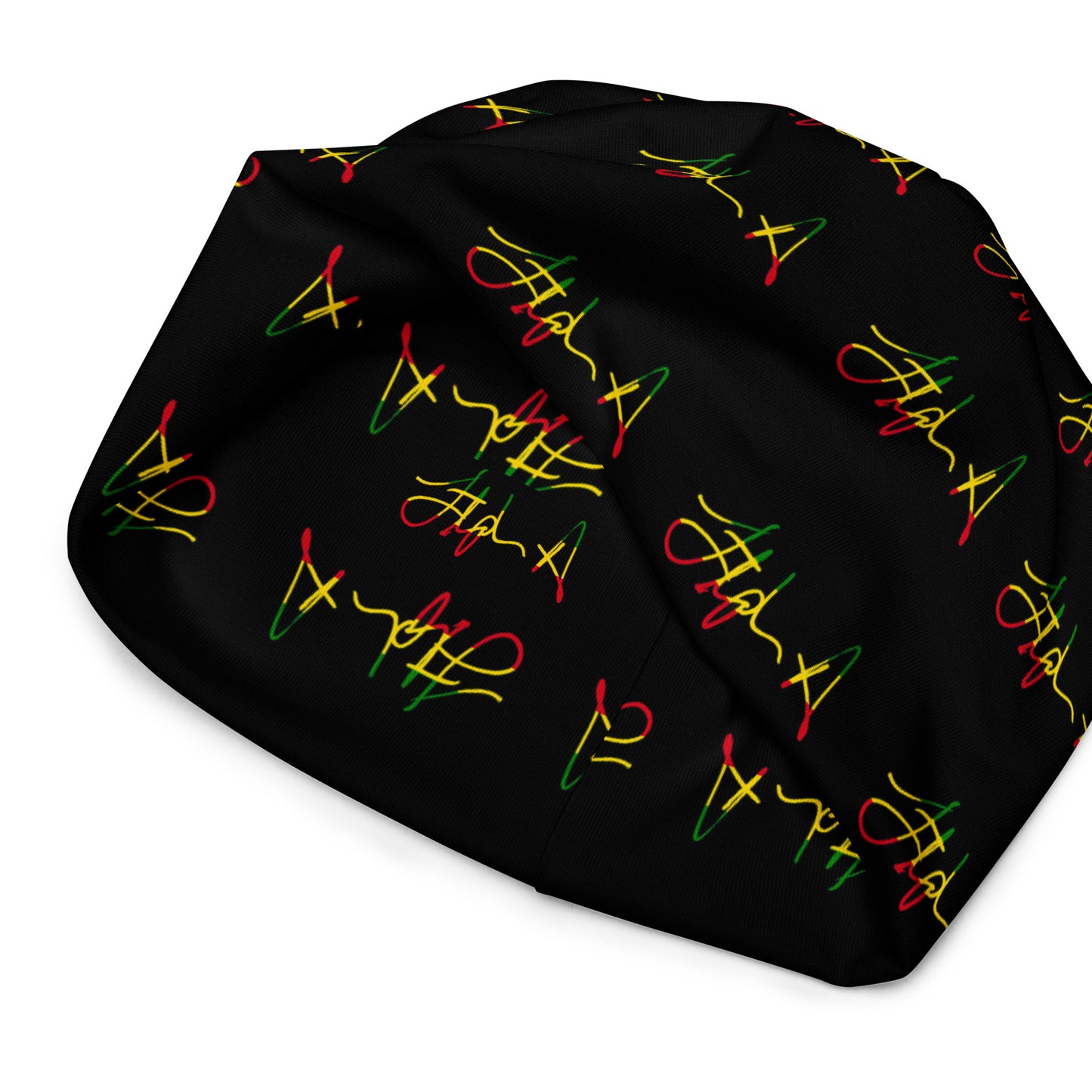 A black beanie hat featuring a repeating pattern of stylized cursive script in red, yellow, and green, resembling the Rastafarian flag colors. Stephen Allen Music