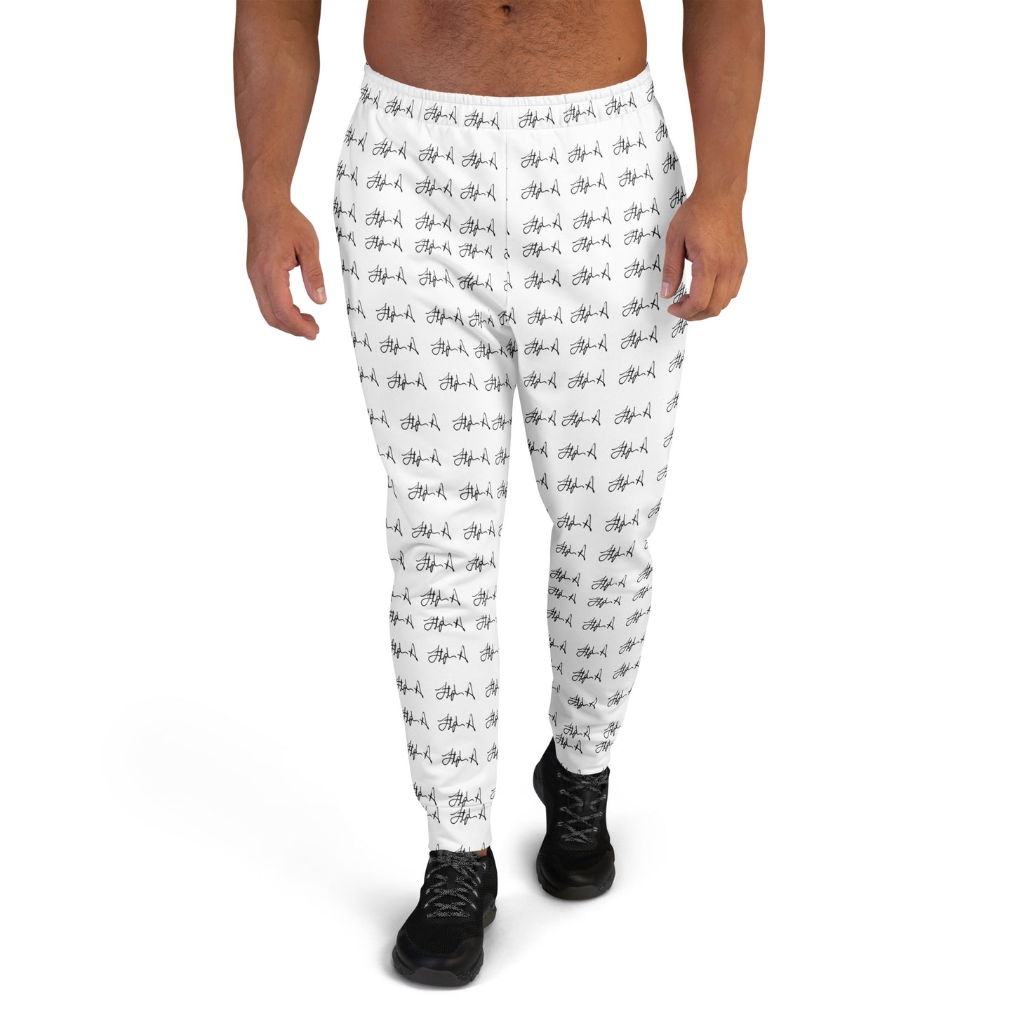 White jogger-style pants with an all-over black script pattern, shown on a male model from the waist down against a plain white background. Stephen Allen Music