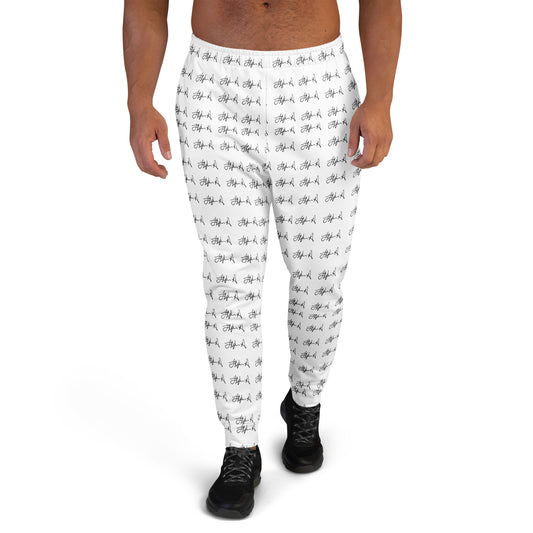 White jogger-style pants with an all-over black script pattern, shown on a male model from the waist down against a plain white background. Stephen Allen Music