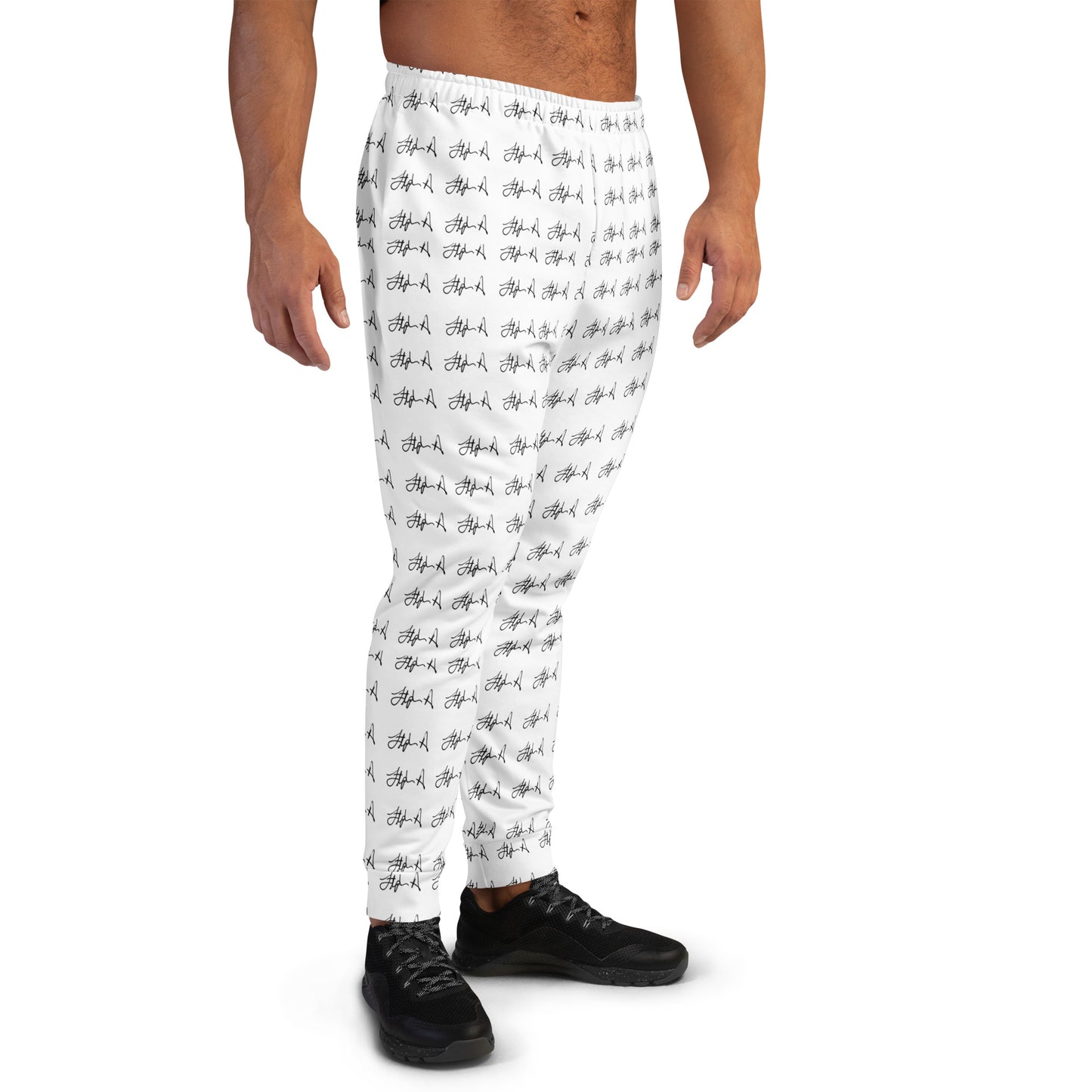 White athletic jogger pants with an all-over black graffiti-style pattern, shown on a male model from the waist down wearing black sneakers against a plain white background. Stephen Allen Music