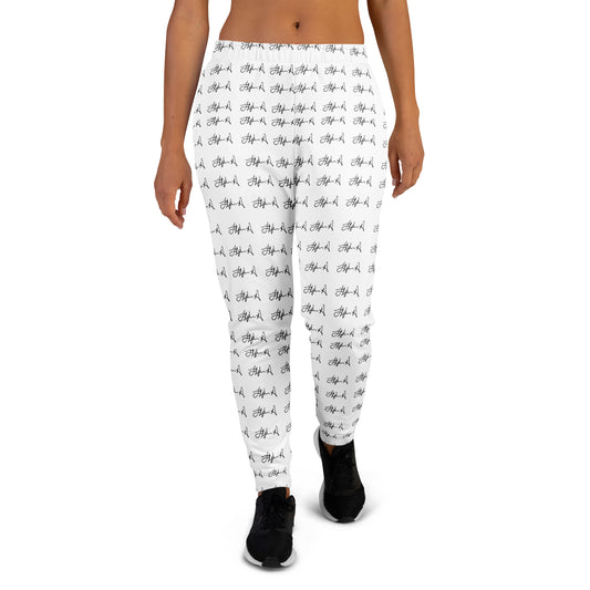 White leggings with a black repeating script pattern, shown on a model from the waist down against a plain white background. Stephen Allen Music