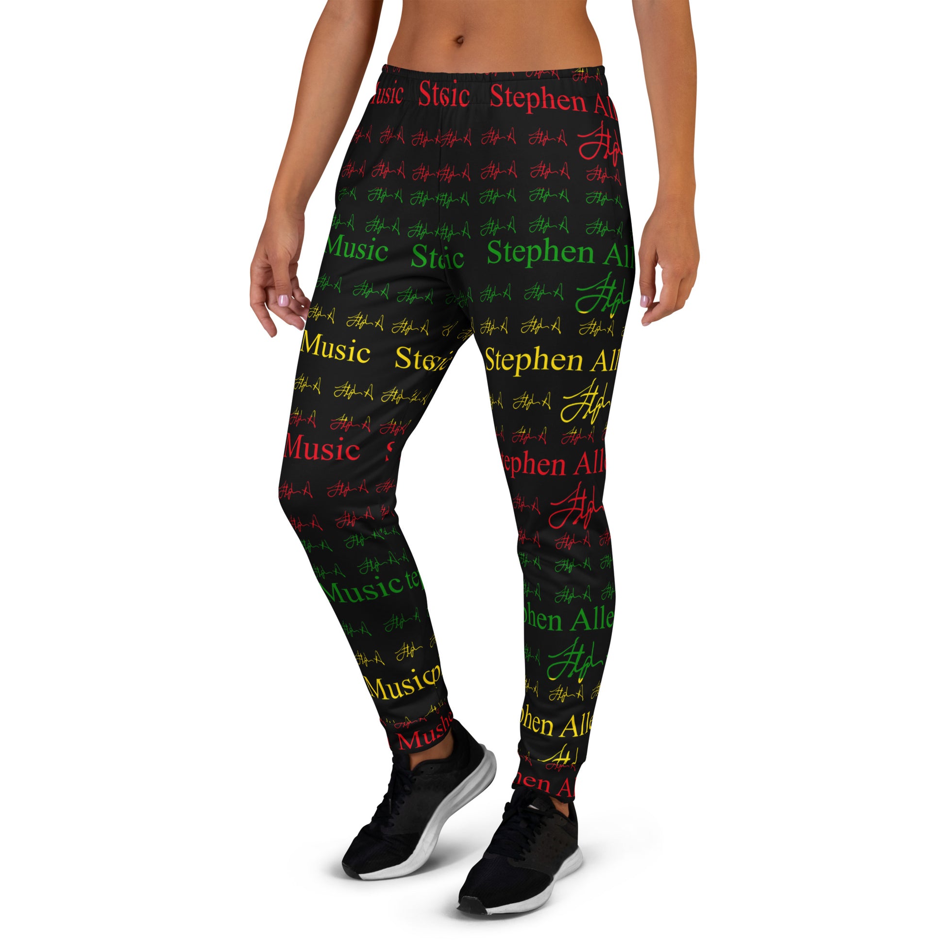 A person modeling patterned leggings against a plain white studio background. The leggings feature an all-over print of the phrase 'Stephen Allen Music' in red, green, and yellow text with repeated signature-style marks.