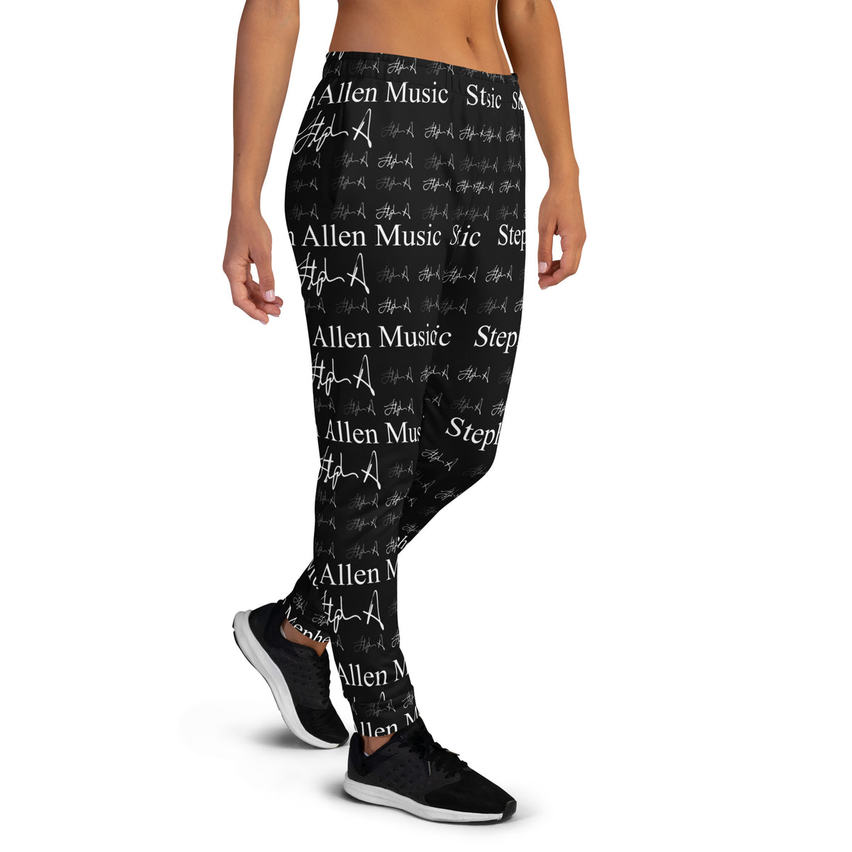 A person wearing black jogger-style pants with an allover white 'Stephen Allen Music' text and script print, shown from the waist down against a plain white background.